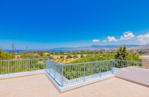 a balcony with a view of the mountains at Happy Village - Latchi in Polis Chrysochous