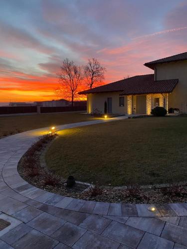a house with a sunset in the background at Villa Sarmassa in Narzole