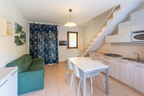 a kitchen and living room with a table and a couch at Isola di Albarella in Isola Albarella