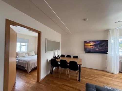 a bedroom with a bed and a table and chairs at Norðurgata 43 in Akureyri