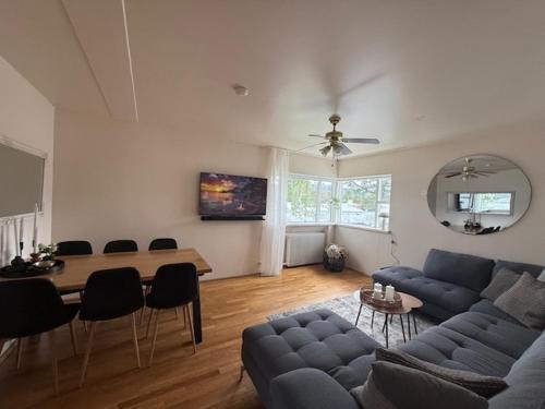 a living room with a blue couch and a table at Norðurgata 43 in Akureyri