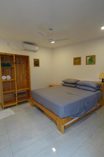 a bedroom with a large bed in a room at Stay Kora in Thinadhoo