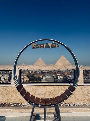 a view of the pyramids from the roof of a building at Sunset of Thebes Pyramids View in Cairo