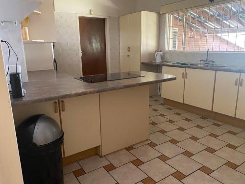 an empty kitchen with a counter and a sink at Lynnwood 246 House in Pretoria