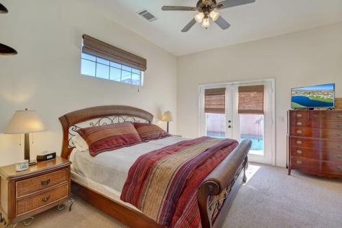 a bedroom with a bed and a dresser and a fan at Villa Escondida in La Quinta