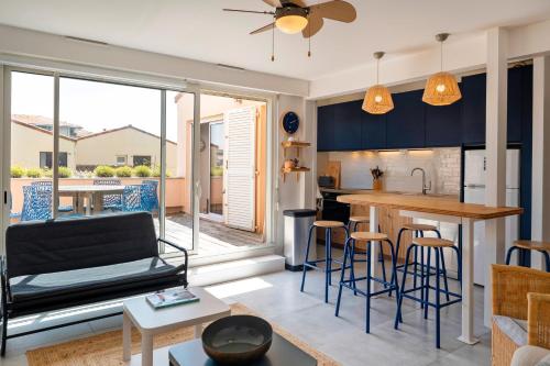 d'une cuisine et d'un salon avec des armoires bleues. dans l'établissement Appartement Notre Dame, à Capbreton