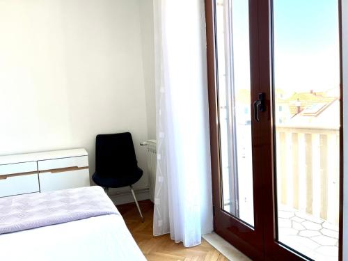 a bedroom with a bed and a window and a chair at Apartment Vito in Postira