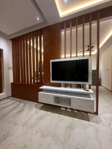 a living room with a large television on a wall at Extasea Beach Villa in Cheyūr