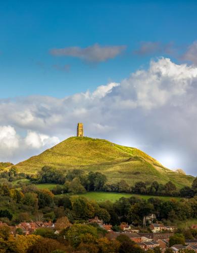 a hill with a tower on top of it at Glastonbury - ContactlessCheckIn - Free Parking in Glastonbury