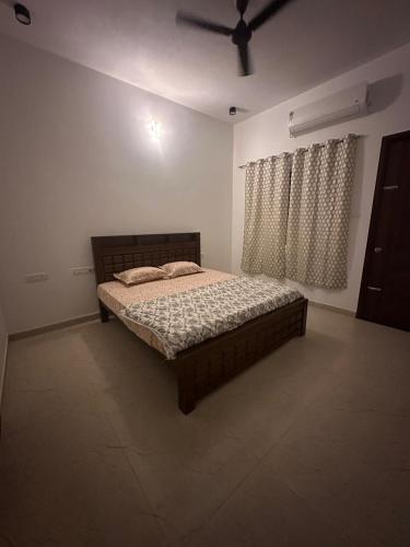 a bedroom with a bed in a white room at Extasea Beach Villa in Cheyūr