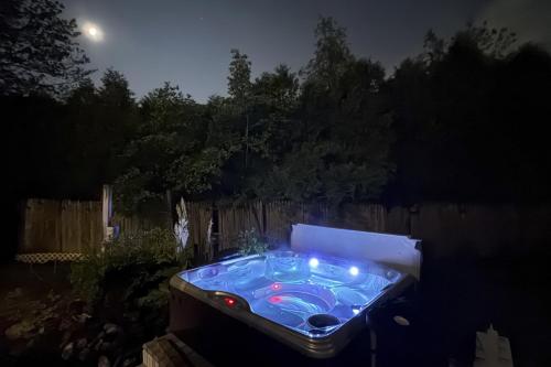 a hot tub in a backyard at night at Salt Air Serenity in Old Orchard Beach