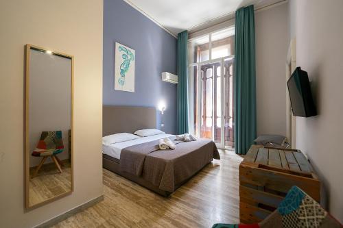 Кровать или кровати в номере GreRos Boutique H Angioino, by ClaPa Group Dislocate Hospitality