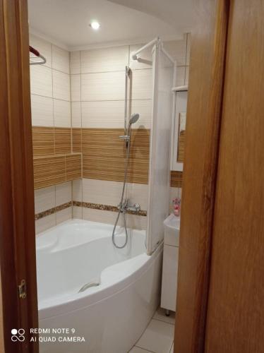 a bathroom with a tub and a toilet at Vienības 34 in Daugavpils