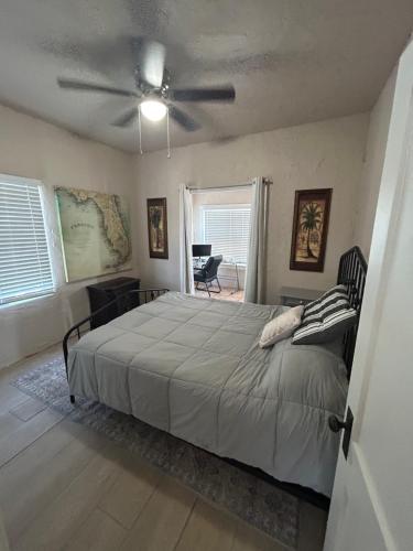 a bedroom with a bed and a ceiling fan at Historic Home near the water - perfectly walkable spot! in Lake Worth