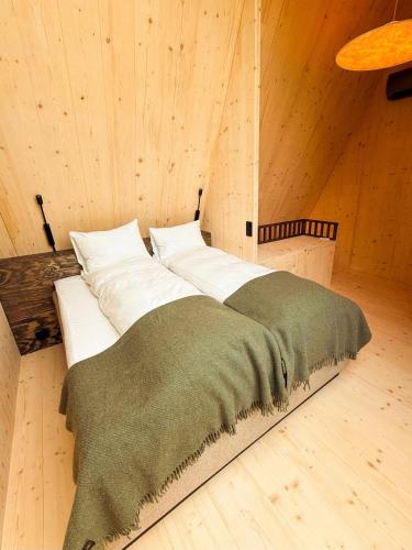 a large bed in a room with wooden walls at Holmen Husky Lodge in Alta
