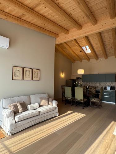 a living room with a couch and a table at La Maison du Lac Iseo 3 in Predore