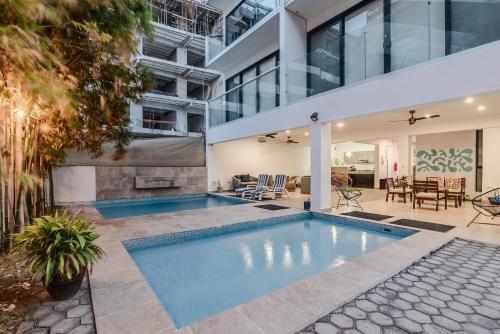 an indoor swimming pool in the middle of a house at Vela's Condos Ocean Front in Puerto Morelos