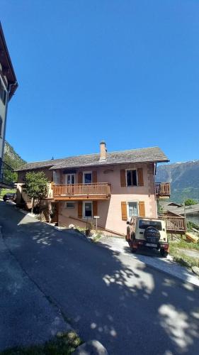 a truck parked in front of a house at Gramimmo - Appartement La Cascade in Salvan