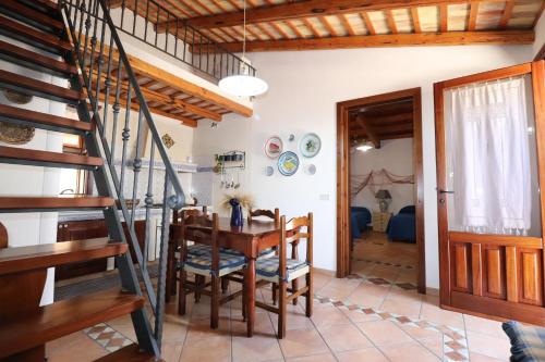 a kitchen and dining room with a table and chairs at EVEN HAVEN Baglio in San Vito lo Capo