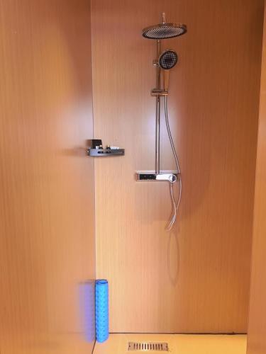 a shower in a bathroom with a shower head at Yushe Shiguang Xiaozhu in Jining