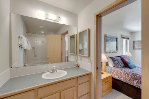 a bathroom with a sink and a bed and a mirror at Tyra Stream 234 by Ski Country Resorts in Breckenridge