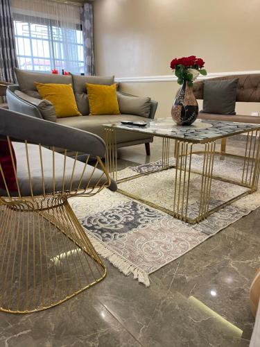 a living room with a couch and a table at JPN SQUARE Douala in Douala