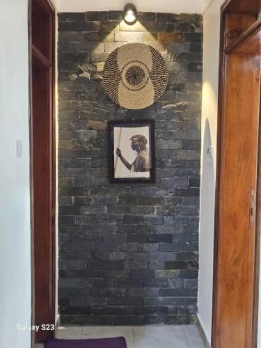 a brick wall with a picture of a dog on it at Spea Residency Apartment in Mbarara