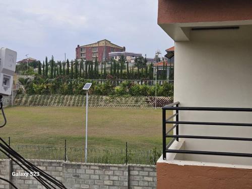 a view of a park from a building with a fence at Spea Residency Apartment in Mbarara