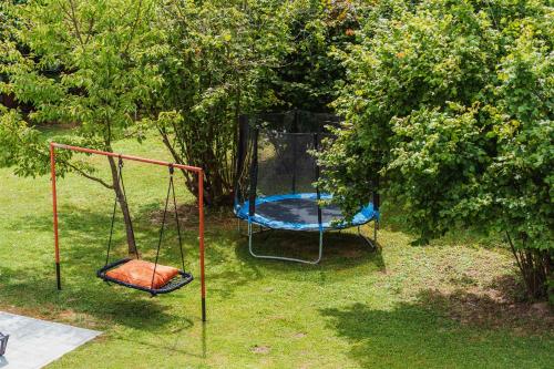 two swings sitting in the grass in a yard at Kuća za odmor Dugo Selo M&A in Dugo Selo