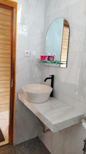 a bathroom with a sink and a mirror at Green Pacing Lodge in Bangli