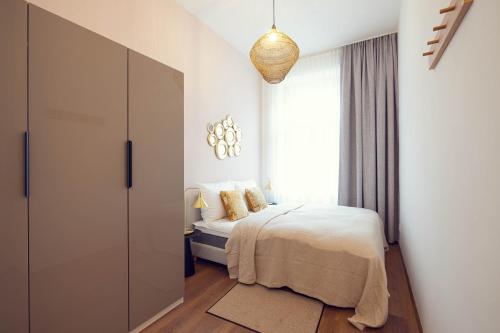 a bedroom with a bed and a large window at LeonArt Living 24 in Graz