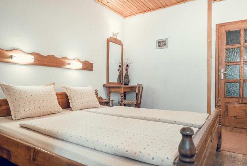 a bedroom with a large bed with a wooden headboard at Complex Popangelov in Borovets