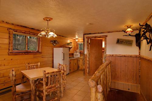 a dining room with a table and a refrigerator at Meadowbrook Resort in Wisconsin Dells