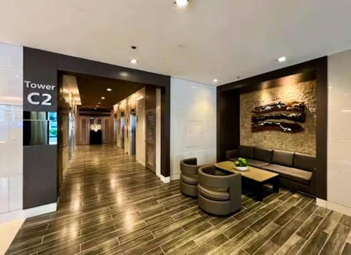 a lobby with a table and stools in a building at SLY Staycation at Shore Residences Mall of Asia in Manila