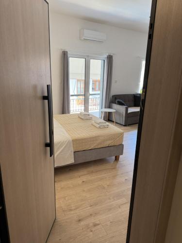 a bedroom with a bed and a living room at Amvrakia Studio in Preveza