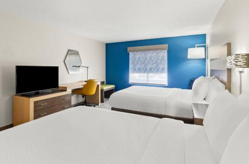 a hotel room with two beds and a flat screen tv at Holiday Inn Express Princeton/I-77 by IHG in Princeton