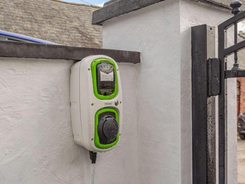 a pay meter on the side of a building at 3 bed in Corwen 86266 in Corwen