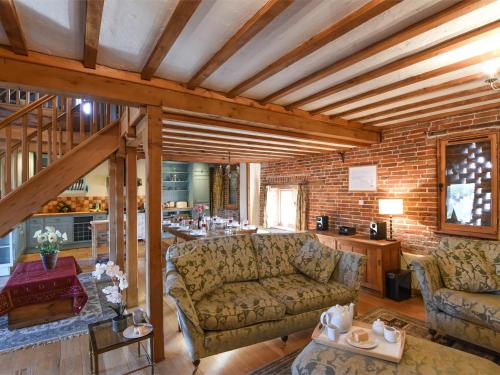 a living room with a couch and a brick wall at 3 Bed in Briston KT187 in Briston