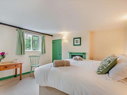 a bedroom with a large white bed and a desk at 3 Bed in Mundesley 90398 in Mundesley