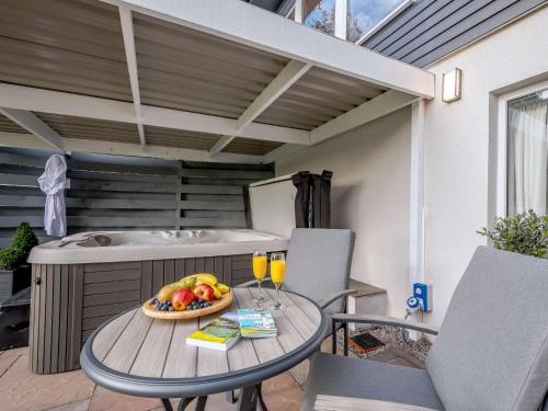 a table with a bowl of fruit and drinks on a patio at 1 Bed in Sandyhills 85904 in Fairgirth