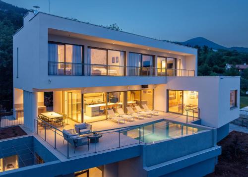 an aerial view of a house with a swimming pool at Villa Ladeti Sereno in Poljane