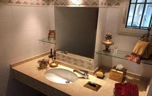 a bathroom with a sink and a large mirror at Majestic Monaco Villa in La Turbie