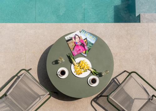 a table with a bowl of fruit and a magazine at Villa Ladeti Sereno in Poljane