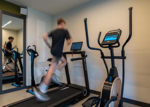 a man running on a treadmill in a gym at Villa Ladeti Sereno in Poljane