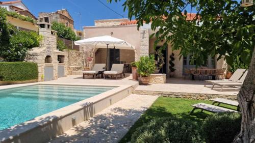 a house with a swimming pool in a yard at Artemis Apollonas Villa I Luxury Escape with Pool in Káïna