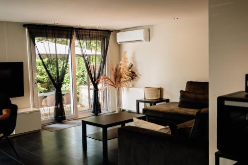 a living room with a couch and a table at Veluwse Wellness Lodge Selina in Ermelo