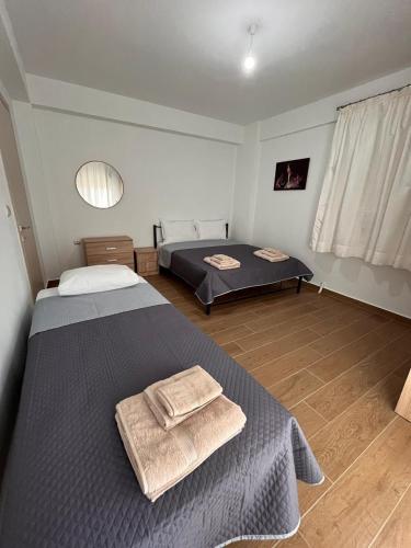 a bedroom with two beds with towels on them at Apartment In Nea Fokea in Nea Fokea
