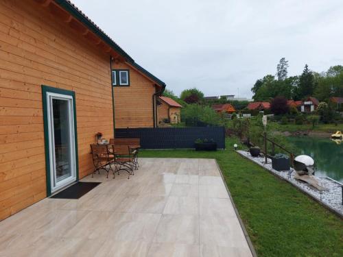 a patio with a table and chairs next to a house at Villa Gloria Spielberg in Spielberg