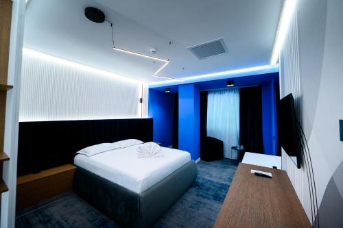 a bedroom with a bed and a blue ceiling at Hotel Bavaria in Craiova