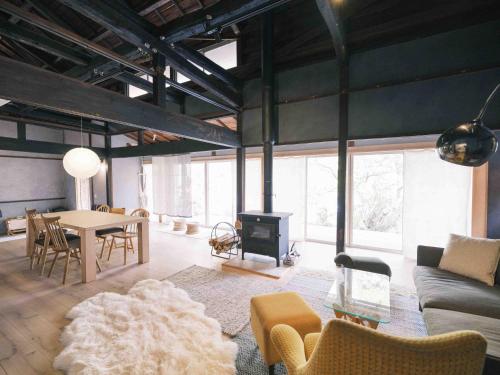 a living room with a couch and a table at 紡舎 - BO-SHA - - 古民家一棟貸しVilla in Akiruno